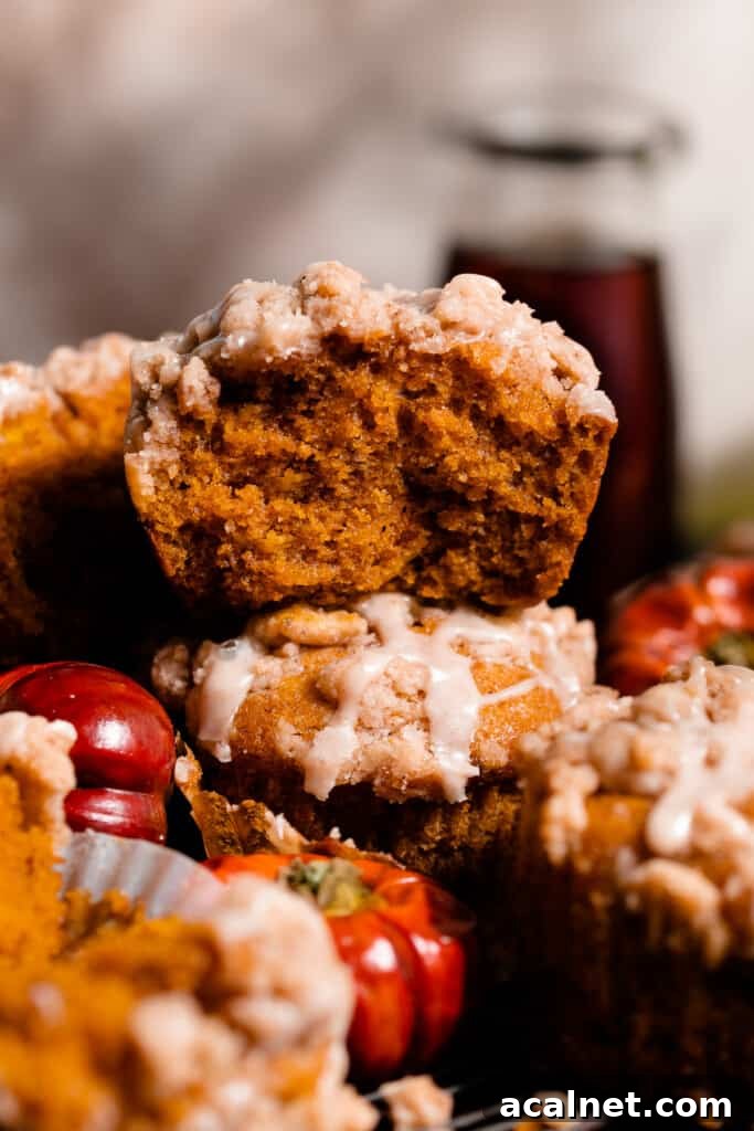 A close-up of half a muffin stacked on another, showing the fluffy insides.