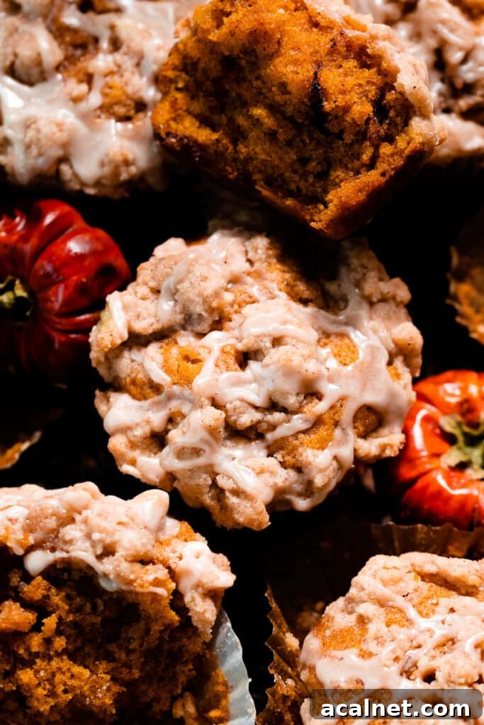 A close-up on the top of a pumpkin muffin showing the streusel and maple glaze.