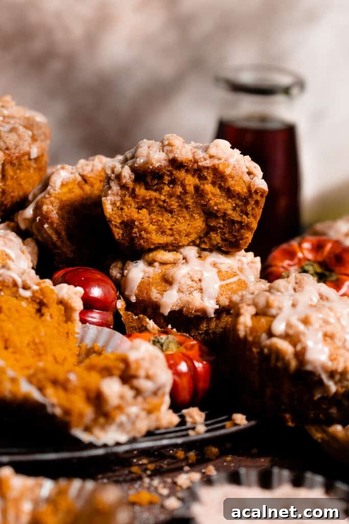 A stack of pumpkin muffins on a vintage wire rack.