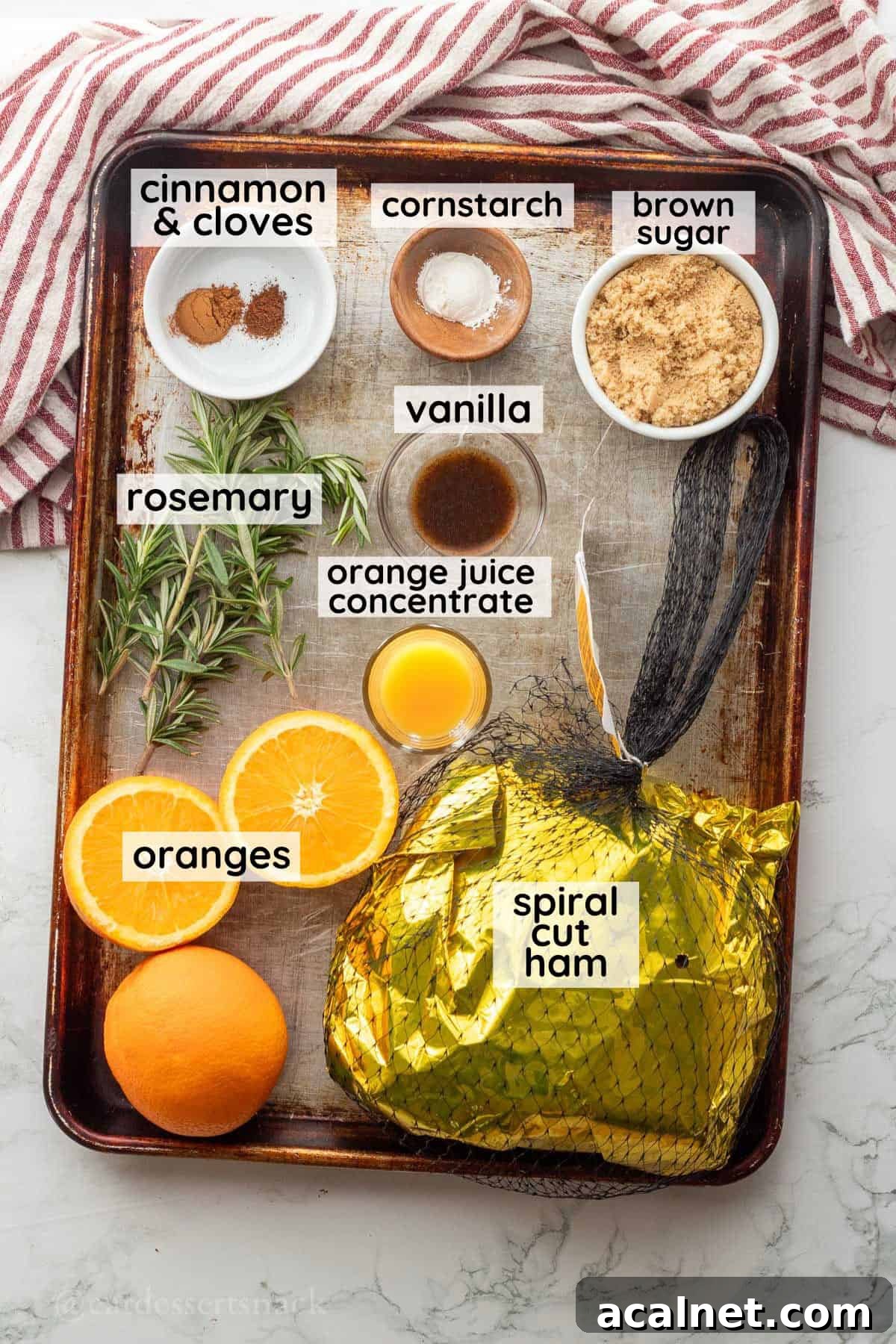 Labeled ingredients for orange ham glaze in glass bowls on metal pan.