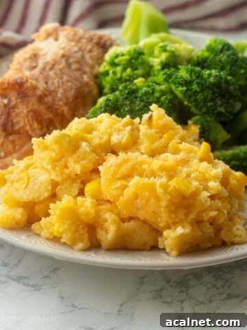 Cooked corn pudding with broccoli and meat on a plate.