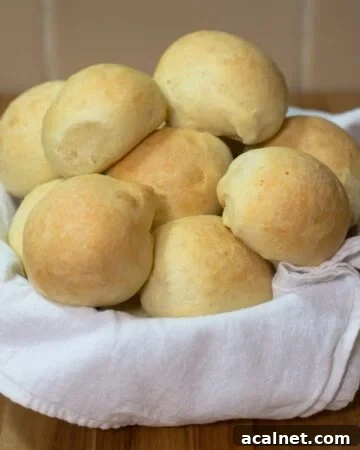 A towel lined basket filled with homemade slider buns.