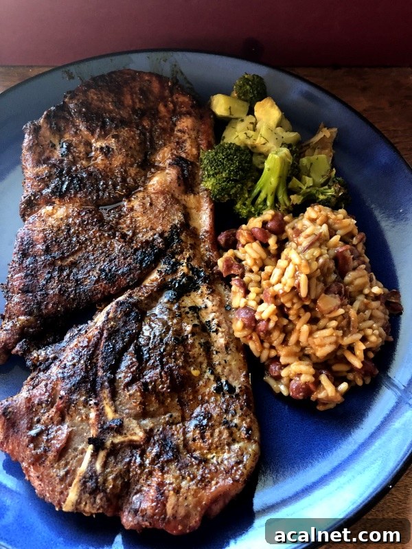 Taco Seasoned Grilled Steaks served with broccoli and beans & rice on blue plate