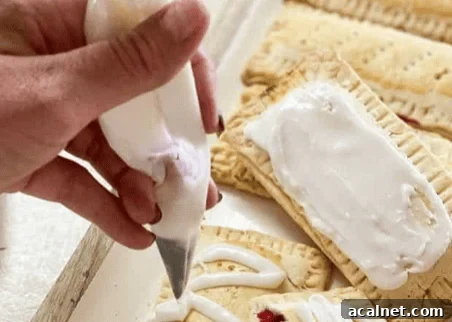 45-Minute Homemade Gluten-Free Pop-Tarts Recipe 7 gluten free pop tarts baked with icing being piped on top