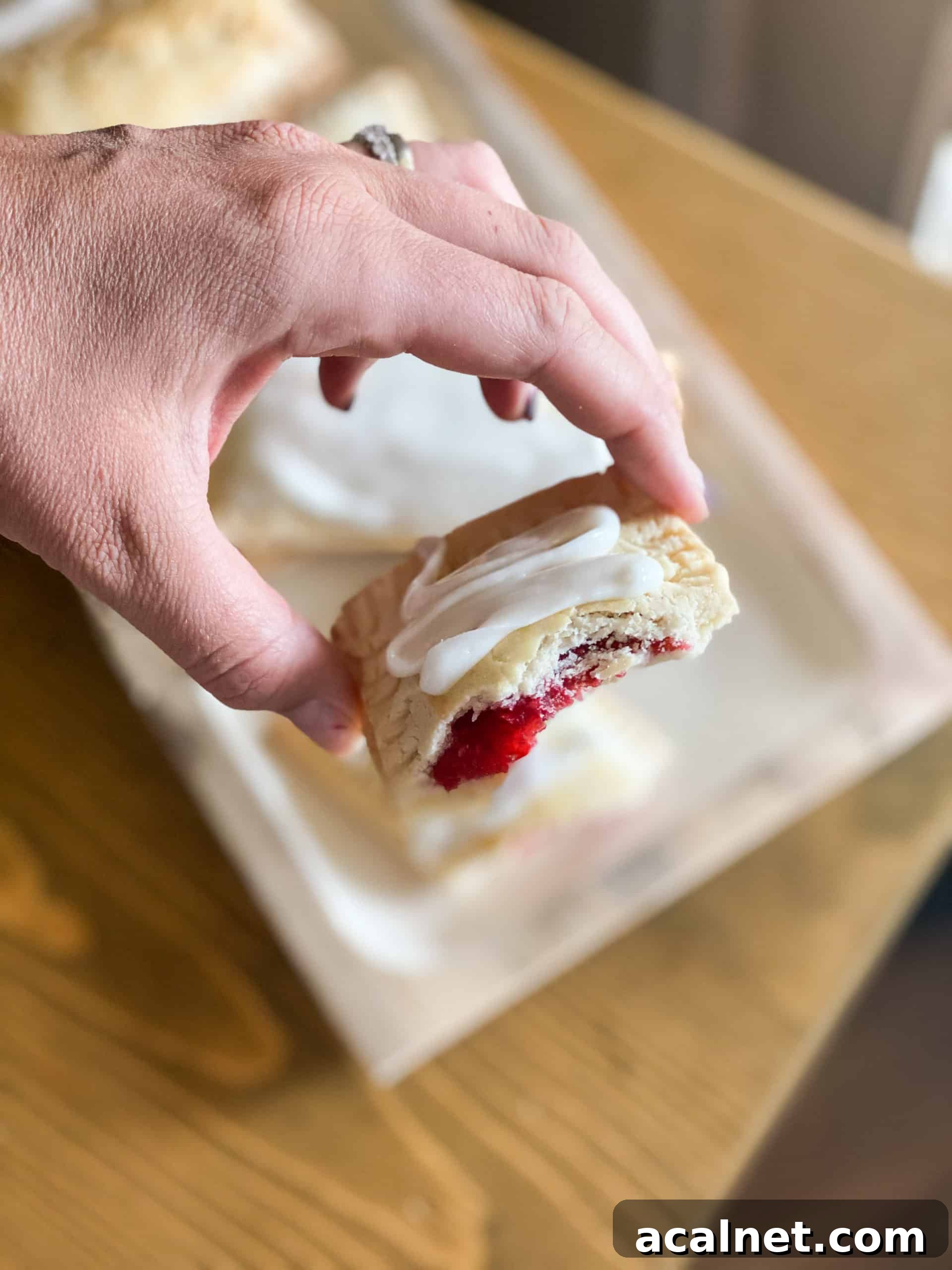 Gluten-Free Pop Tarts Gluten-Free Pop Tarts in a hand with raspberry filling