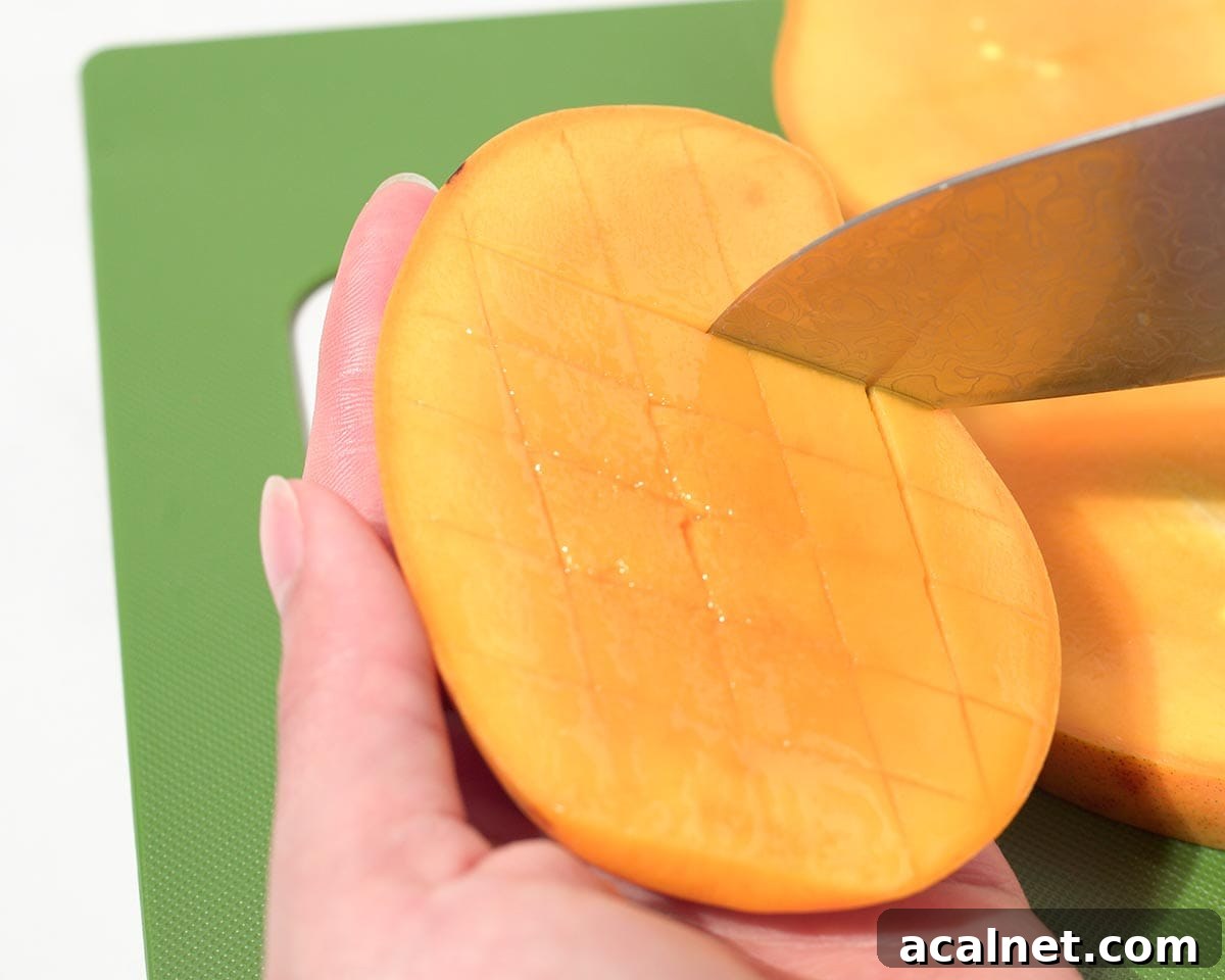 Cutting slices into the mango.