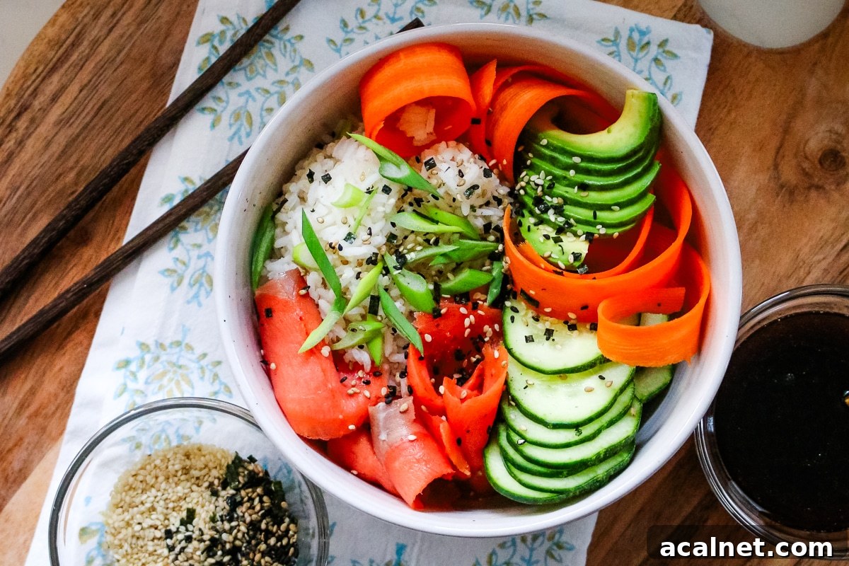 Smoked Salmon Poke Bowl with Avocado, Sesame and Lime 9 Smoked salmon in a white bowl, served with sesame seeds and soy sauce on the side.