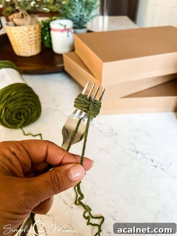 Fork used to wrap yarn to make a mini pompom