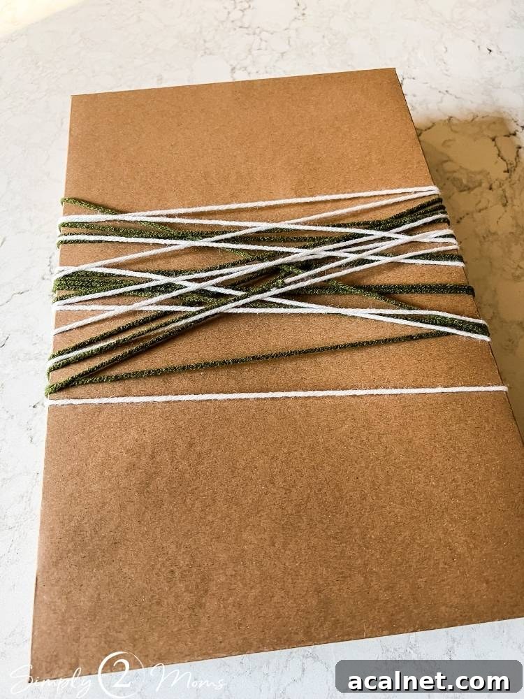 Kraft shirt box with white and green yarn wrapped and crisscrossed