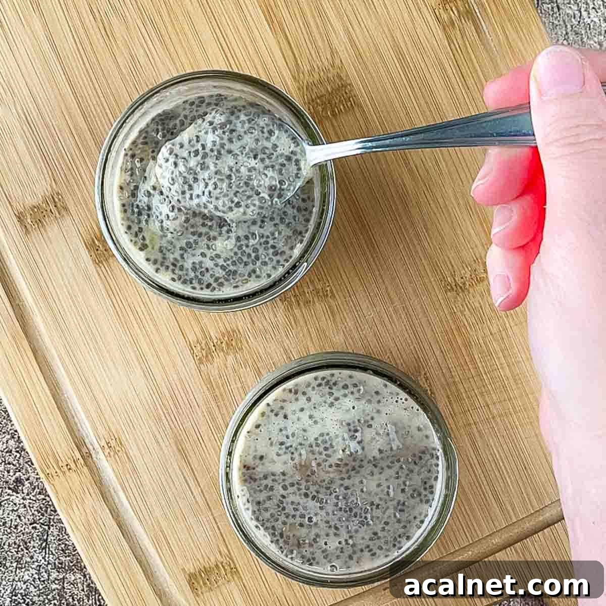 Creamy Banana Chia Seed Pudding Recipe 6 A spoon with a scoop of thickened chia pudding on it.