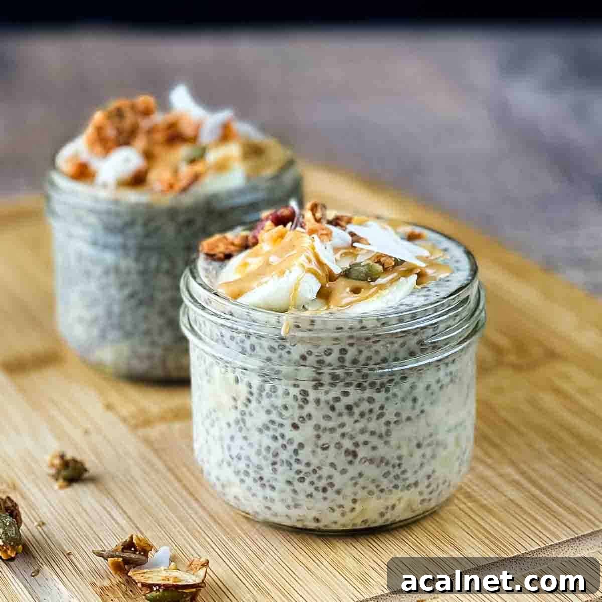 Creamy Banana Chia Seed Pudding Recipe 8 The two jars of banana chia seed pudding garnished with bananas, granola, and coconut.