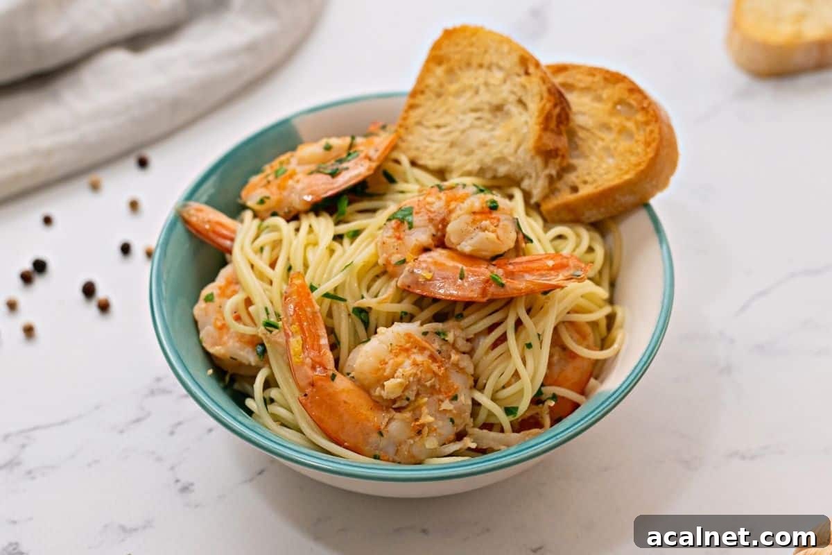 Shrimp Scampi Pasta in blue and white dish with garlic toast.