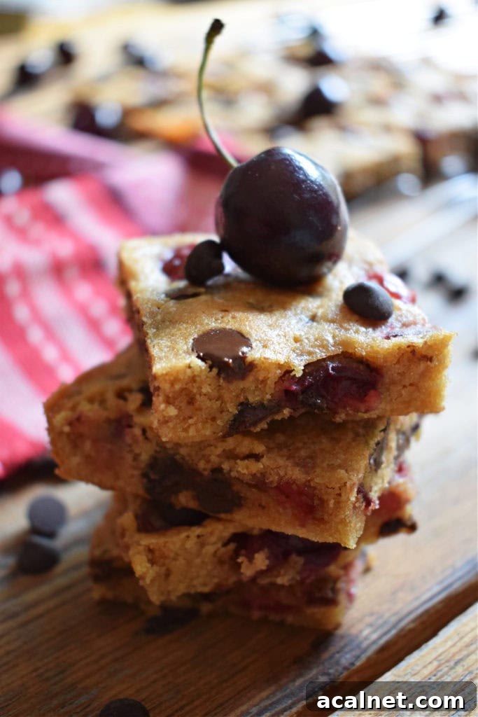 a stack of cherry chocolate chip blondies