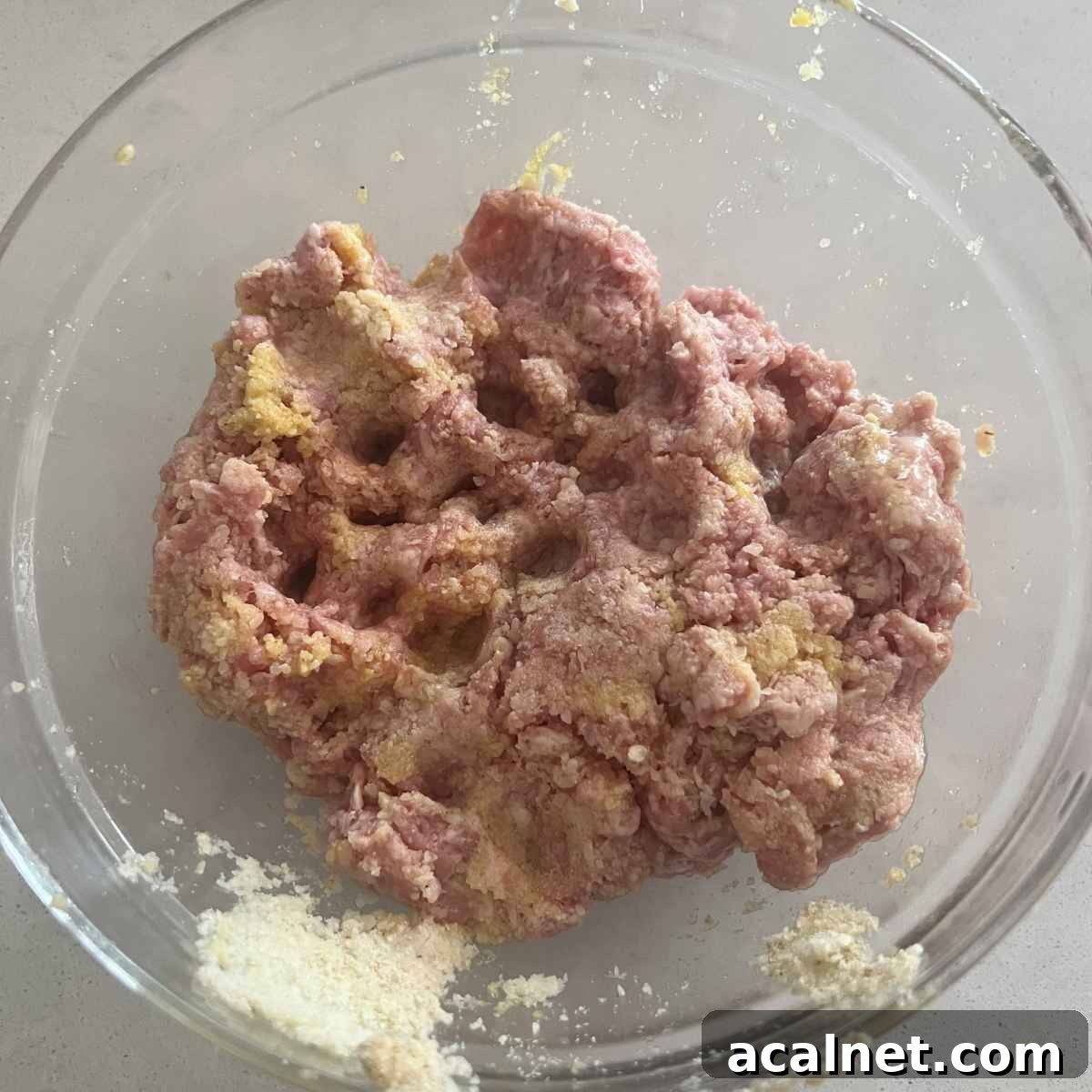 Smoked Meatballs with Tangy BBQ Glaze 3 Smoked meatball mixture in a glass bowl.