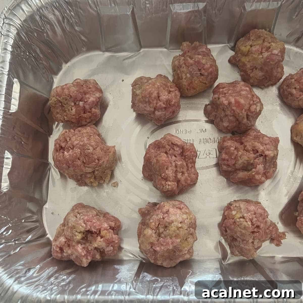 Smoked Meatballs with Tangy BBQ Glaze 4 Rolled smoked meatballs in a tinfoil container for smoker.