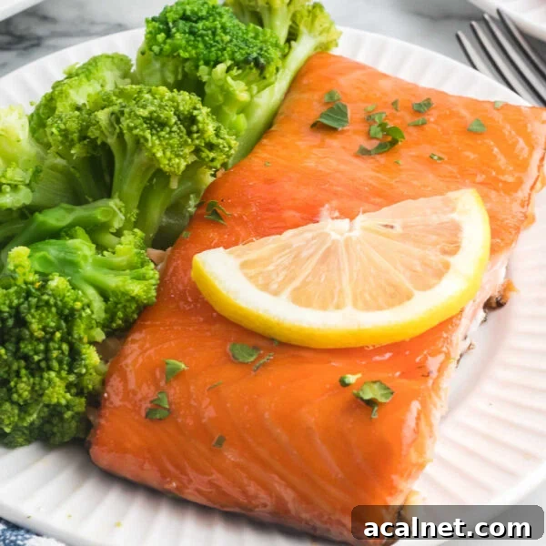 Salmon and broccoli on a white plate.