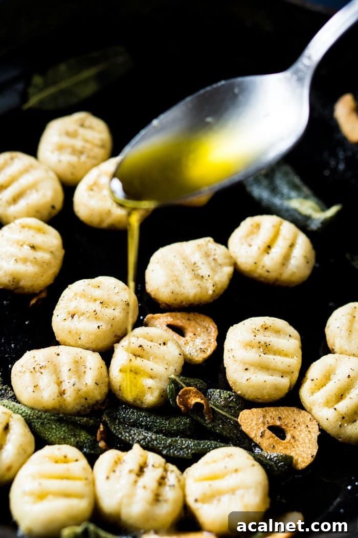 Drizzling olive oil onto keto ricotta gnocchi