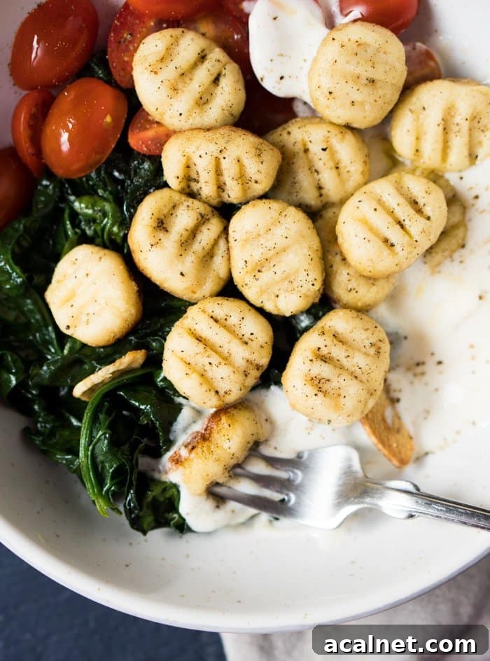 Gluten free & keto ricotta gnocchi with spinach, cherry tomatoes and yogurt sauce