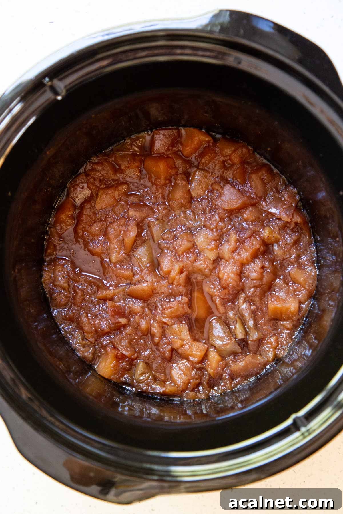 Slow Cooker Apple Butter Recipe: Homemade Fall Spread 3 Cooked apple mixture in a slow cooker.