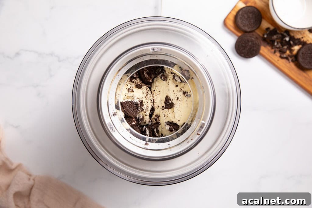 A churned cookies and cream mixture in an ice cream machine