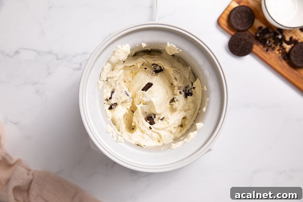 A churned cookies and cream mixture in an ice cream machine
