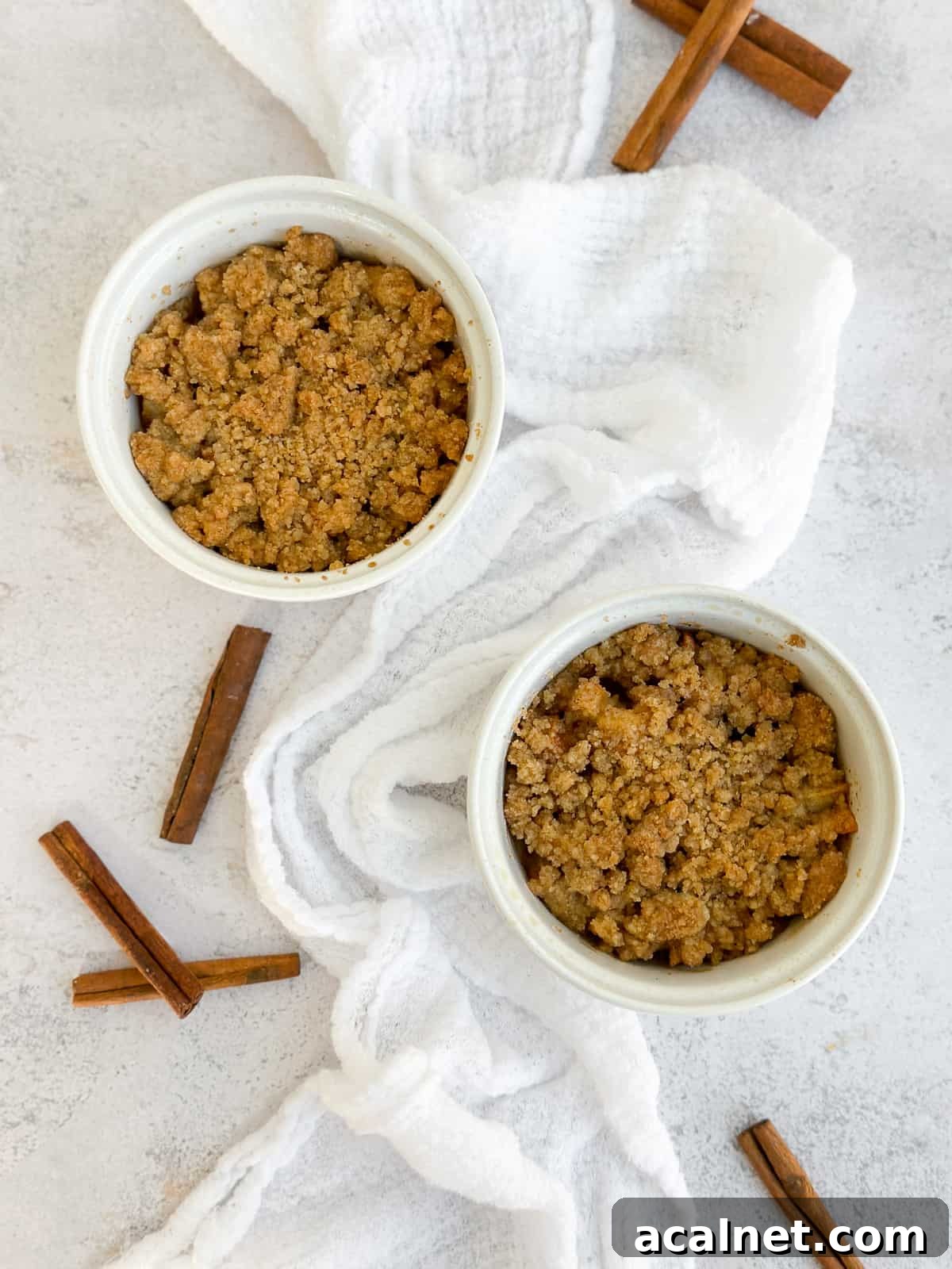 apple crumble for two with a napkin next to them.