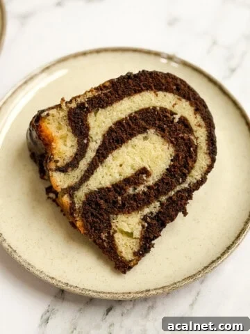 a single slice of marble bundt cake on a plate so you can see all the marbling.