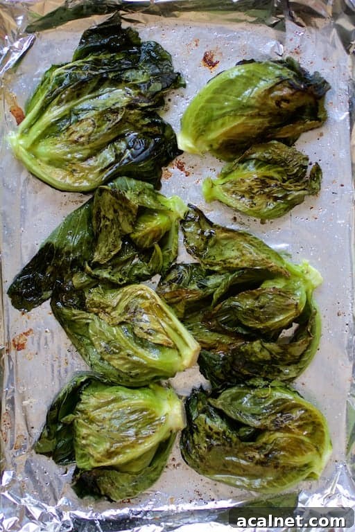 Photo of cabbage sprouts on baking sheet after being roasted.