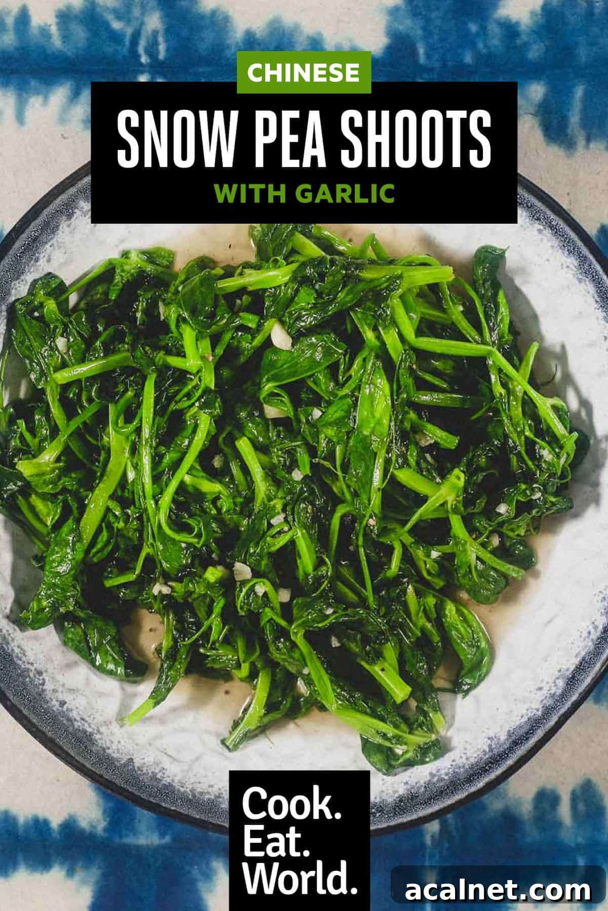 A platter of stir fried sno pea shoots on a blue batik background