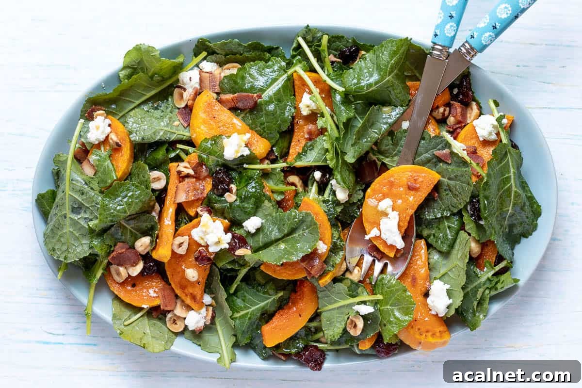 19 Fall Harvest Salads to Brighten Your Table 2 kale butternut squash salad on large platter with tongs.