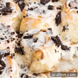 Cookies and Cream Cheesecake with Oreo Crust 10 a close up shot of Cookies and Cream Cinnamon Rolls with a piece taken out