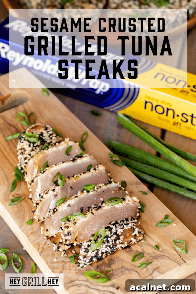 Grilled and sliced tuna steak on a wooden cutting board with text overlay - Sesame Crusted Grilled Tuna Steaks.