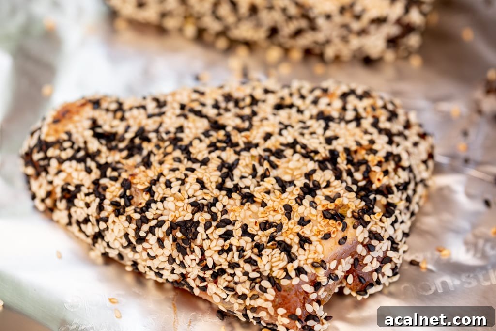 Sesame crusted grilled tuna steak on a sheet of aluminum foil.