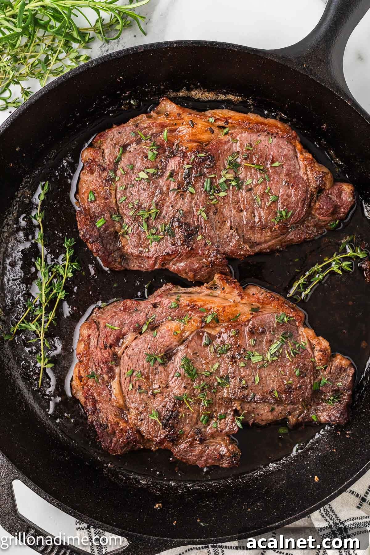 Steak and fresh herbs in a cast iron skillet