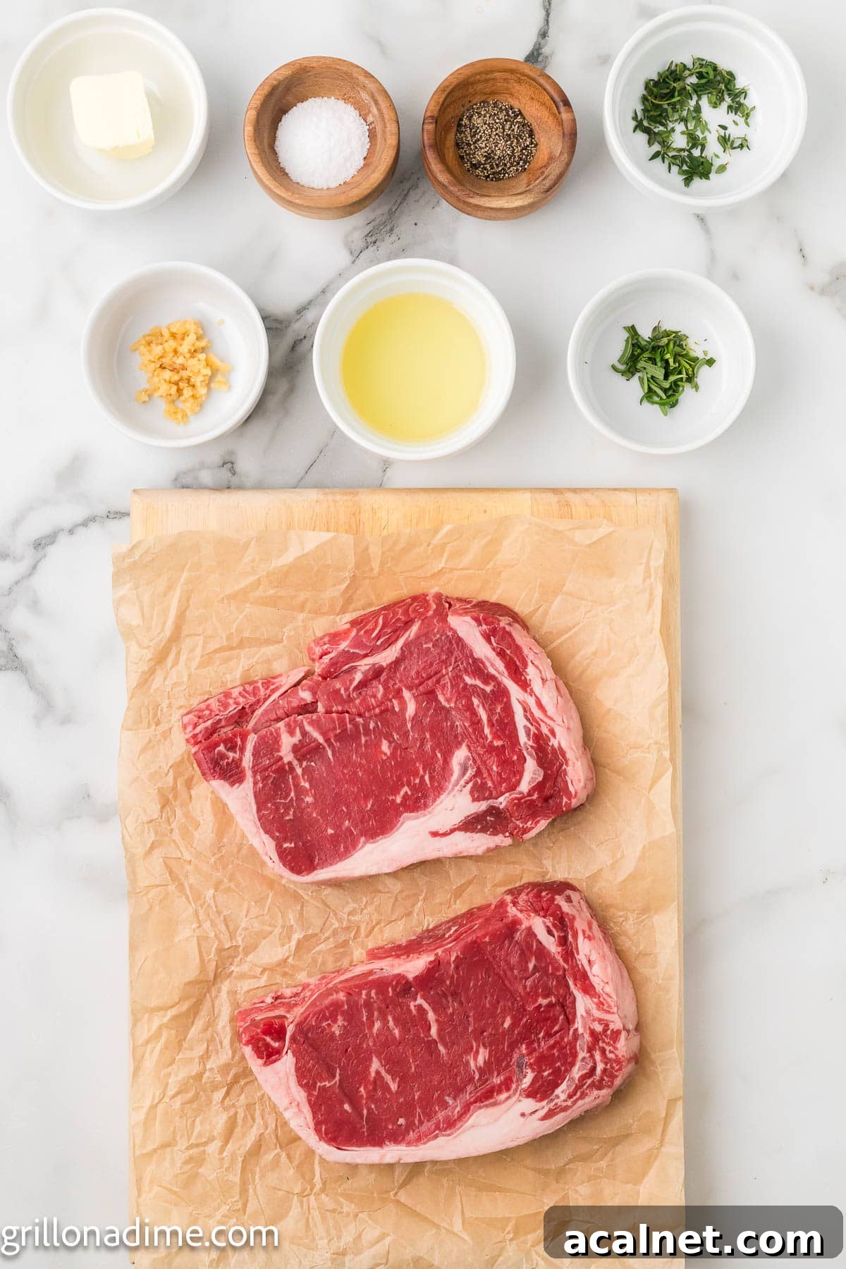 Ingredients needed for cast iron steak - ribeye steak, avocado oil, salt, pepper, garlic, fresh rosemary, fresh thyme, butter