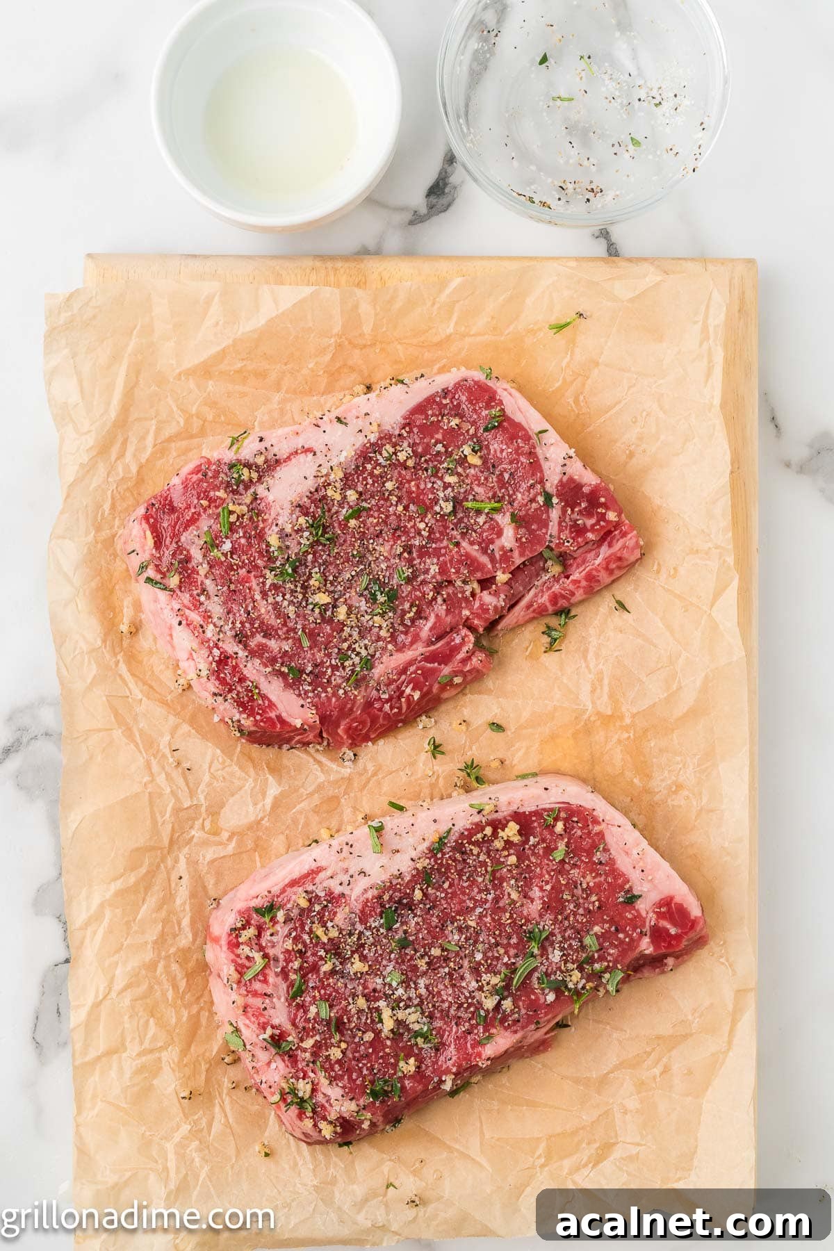 Rubbing the steaks with the fresh herbs