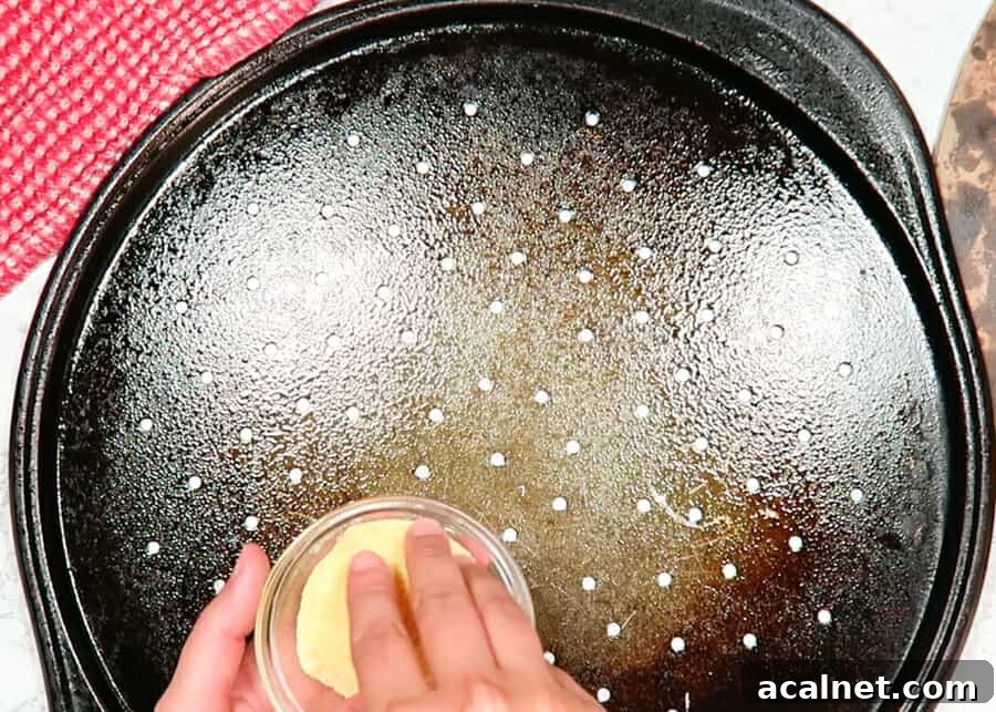 sprinkling corn meal on the pan to bake the thin crust pizza dough