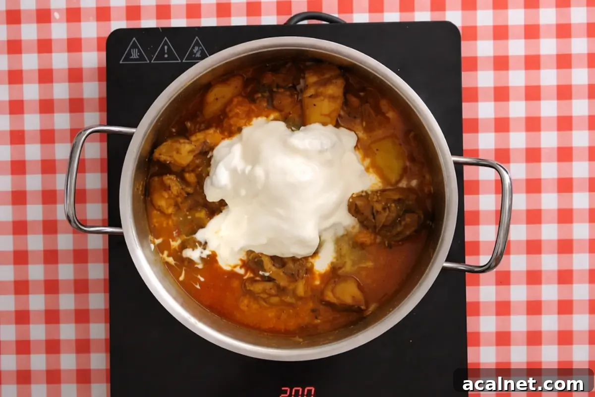 Low FODMAP Chicken Curry for Sensitive Stomachs 7 Yoghurt and cream added to the chicken curry before the final simmer.