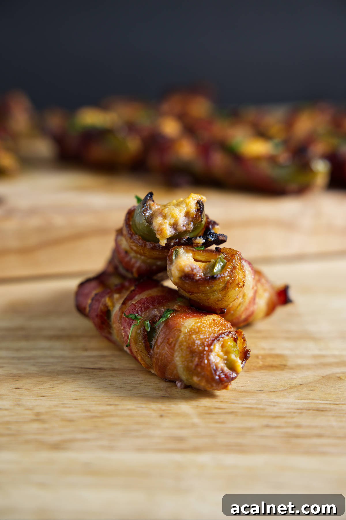 Several jalapeño poppers on a cutting board, ready for eating!