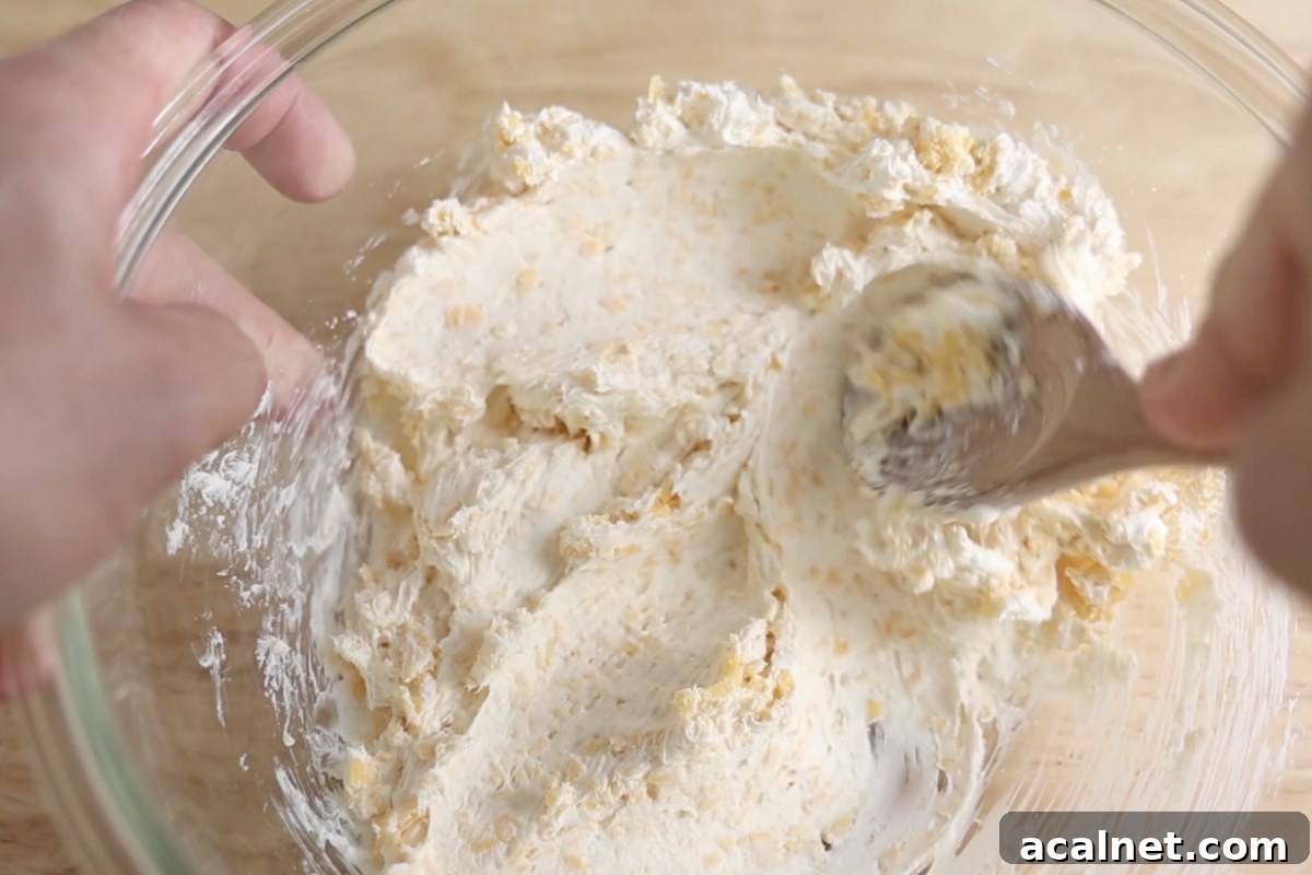 Mixing cheese filling mixture for jalapeno poppers.