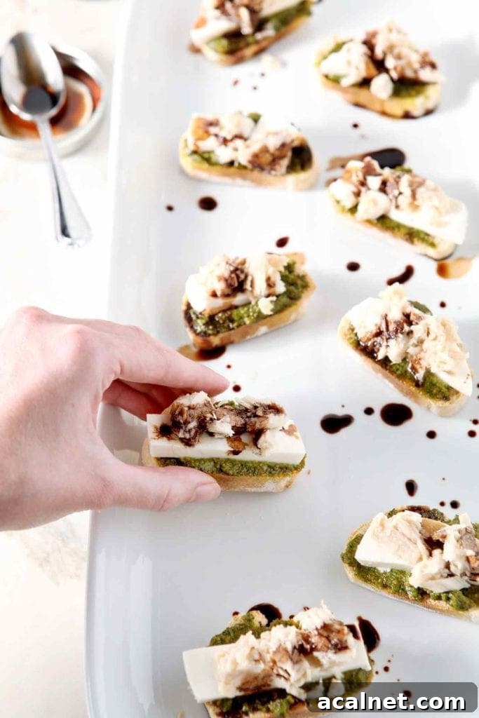 hand grabbing a tuna pesto crostini