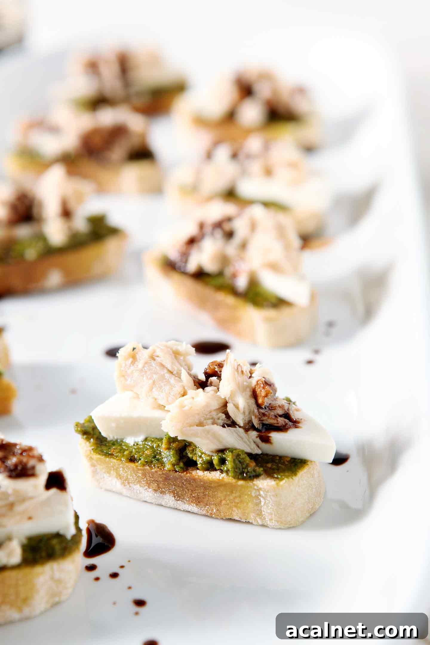 tuna pesto crostini on a white tray
