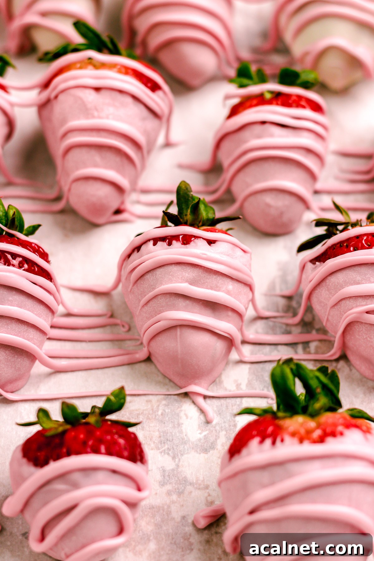 Finished pink chocolate covered strawberries on a plate
