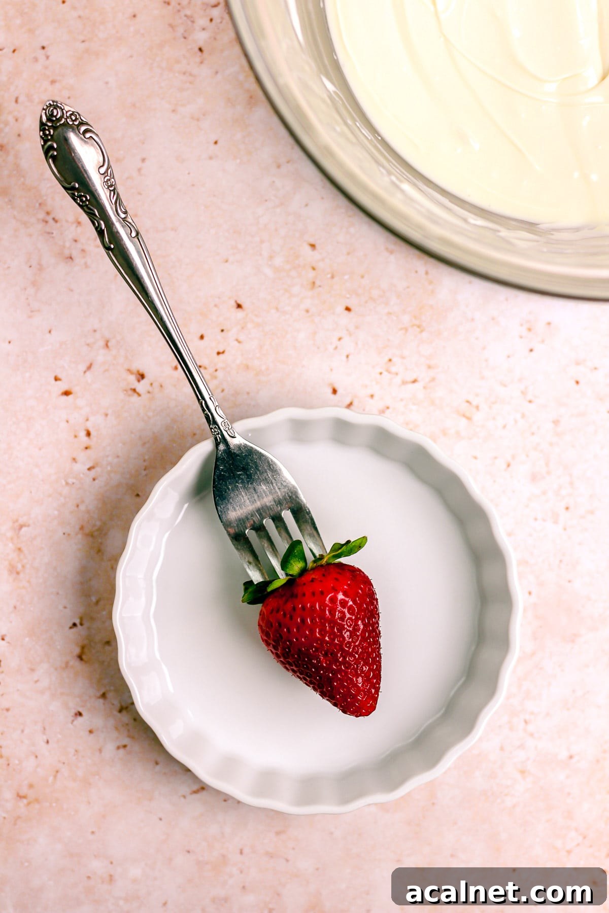 Poking strawberry with toothpick