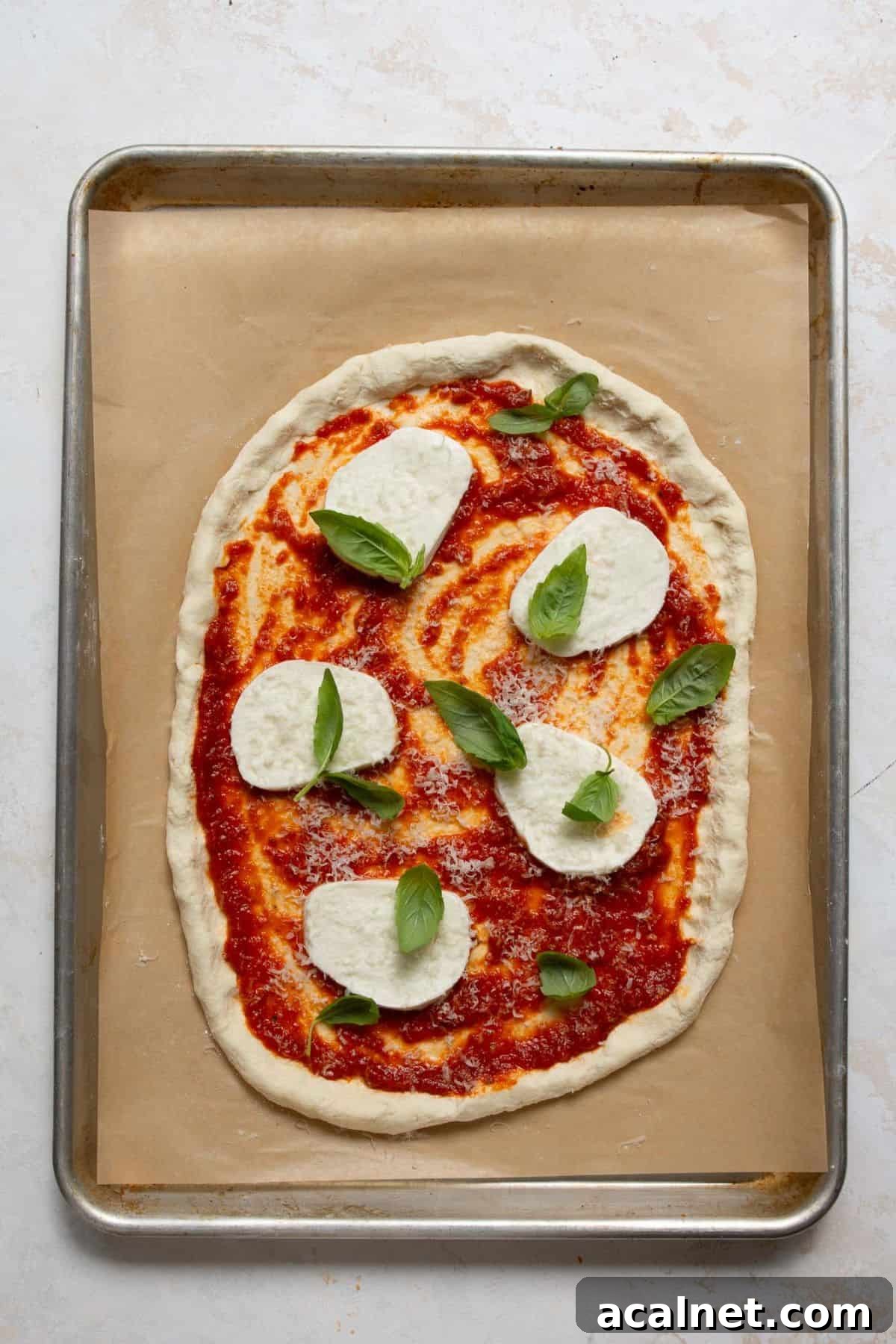 Homemade Greek Yogurt Pizza Dough: Soft, Quick Recipe 11 Adding mozzarella slices and fresh basil to Greek Yogurt Pizza Dough for a Margherita pizza.