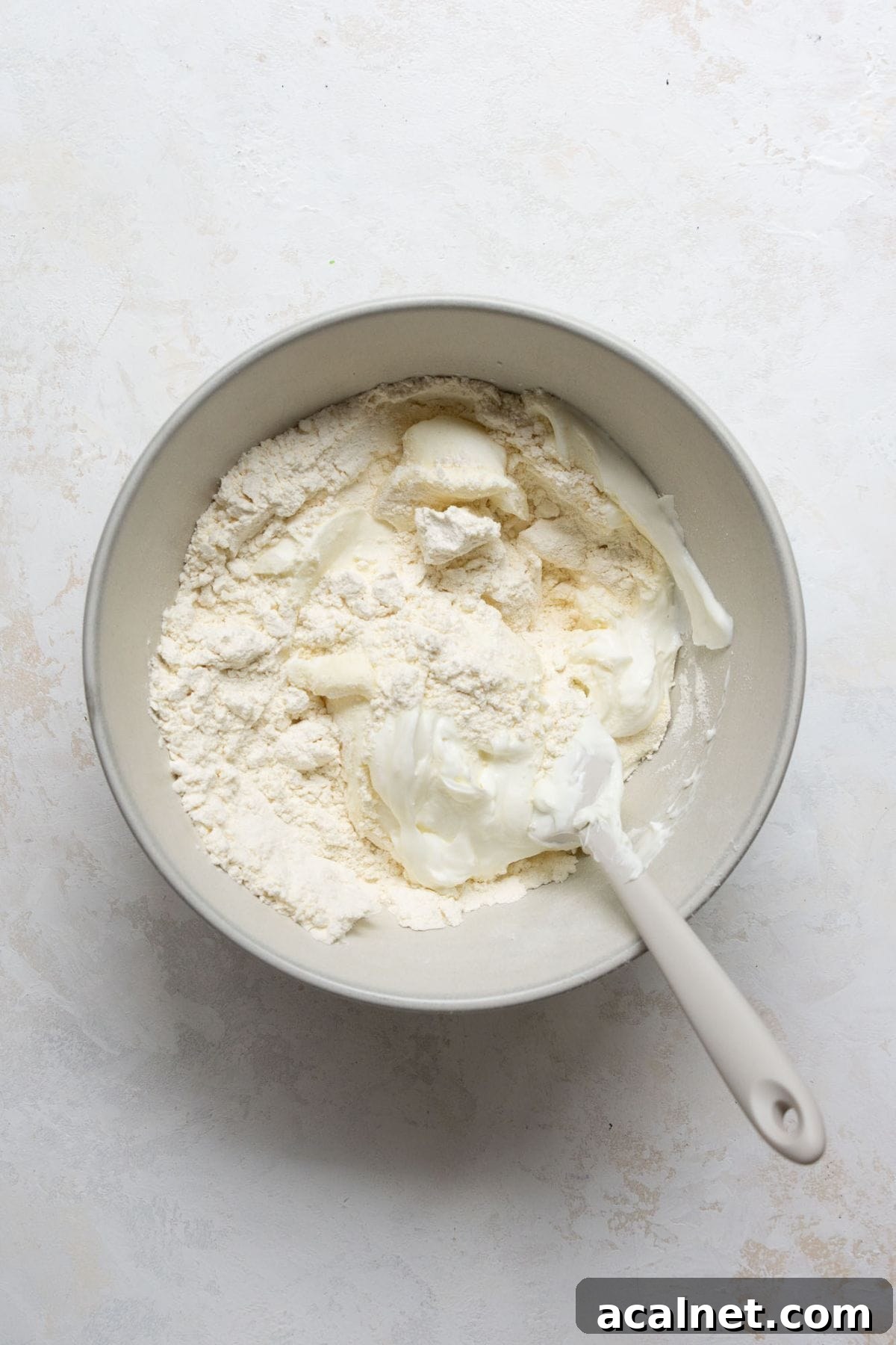 Homemade Greek Yogurt Pizza Dough: Soft, Quick Recipe 5 Self-rising flour and Greek yogurt in a mixing bowl for pizza dough.