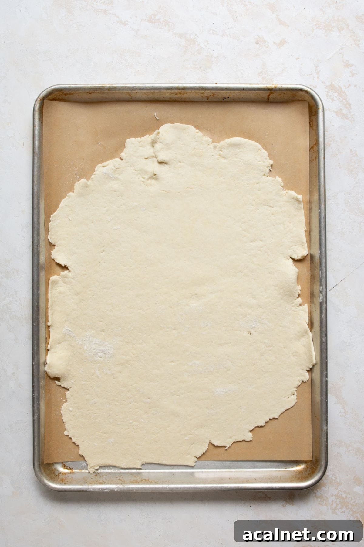 Homemade Greek Yogurt Pizza Dough: Soft, Quick Recipe 8 Thin Greek Yogurt Pizza Dough rolled out on a parchment-lined baking sheet.