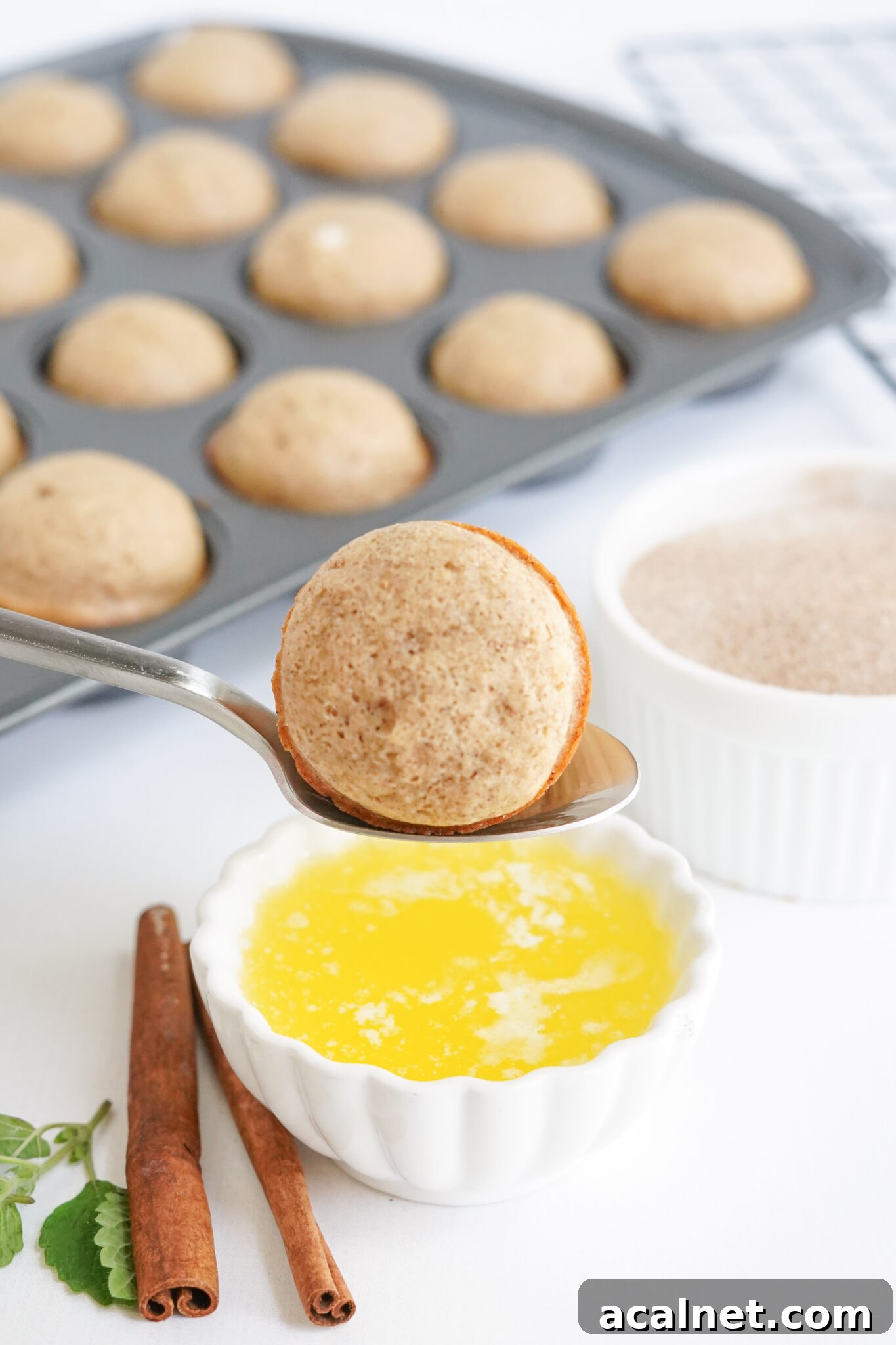 Apple Cider Donut Hole being dipped in butter