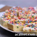 A plate of sugar cookie bars with sprinkles.
