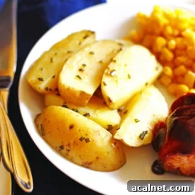 A plate with roasted potato wedges, corn, and bbq chicken.